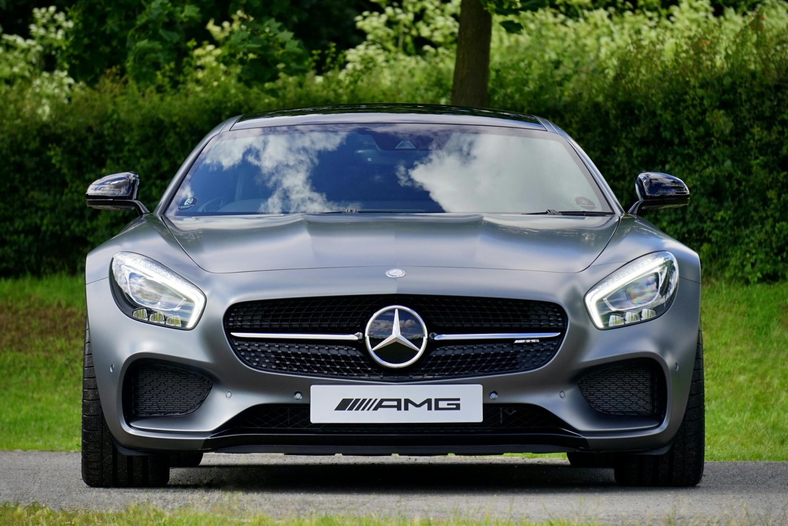 Front view of a luxury Mercedes-Benz AMG against a natural backdrop.